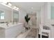 Bathroom features double sink vanity, vanity area, large mirror, and tile floor at 1990 Main St # 10, Sarasota, FL 34236