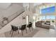 A spacious living room features expansive windows with picturesque views and neutral-toned furnishings at 1990 Main St # 10, Sarasota, FL 34236