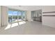 Open living room with sliding glass doors to balcony and an adjacent den at 1990 Main St # 10, Sarasota, FL 34236
