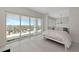Bedroom with city views from a large window, bright white tile, and simple yet elegant decor at 1990 Main St # 10, Sarasota, FL 34236