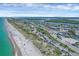 Stunning aerial view of the beach, coastal road, and nearby community offering beautiful waterfront living at 2350 N Beach Rd # 1A, Englewood, FL 34223