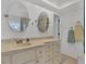 Bright bathroom featuring a long vanity with double sinks, ample storage, and modern fixtures at 2350 N Beach Rd # 1A, Englewood, FL 34223
