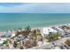Aerial shot showcasing the beachfront buildings against the clear turquoise ocean at 2350 N Beach Rd # 1A, Englewood, FL 34223