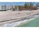 Aerial view of a beachfront property with white sand and clear blue water at 2350 N Beach Rd # 1A, Englewood, FL 34223