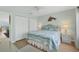 Relaxing bedroom with a queen size bed, white wicker furniture, and ocean themed decor at 2350 N Beach Rd # 1A, Englewood, FL 34223