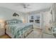 Cozy bedroom with a queen size bed, coastal-themed decor, and a ceiling fan at 2350 N Beach Rd # 1A, Englewood, FL 34223