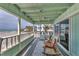 Relaxing covered porch with rocking chairs and ocean view at 2350 N Beach Rd # 1A, Englewood, FL 34223
