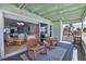 Inviting covered deck with sliding glass doors, comfortable chairs and a view of the ocean at 2350 N Beach Rd # 1A, Englewood, FL 34223