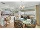 Bright dining area with a round glass table, beach views, and bar seating at 2350 N Beach Rd # 1A, Englewood, FL 34223