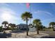 Entrance view of Englewood Beach Park with American flag, palm trees, and signage at 2350 N Beach Rd # 1A, Englewood, FL 34223