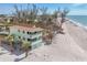 Lovely beachside home with balconies, surrounded by lush greenery, offering stunning coastal views at 2350 N Beach Rd # 1A, Englewood, FL 34223