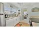 Bright kitchen with stainless steel appliances, white cabinetry, and a view of the ocean from the doorway at 2350 N Beach Rd # 1A, Englewood, FL 34223