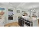 Well-lit kitchen featuring modern appliances, including a built-in oven, with a view to the ocean and dining area at 2350 N Beach Rd # 1A, Englewood, FL 34223