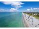 Bustling beachfront with sunbathers and crystal-clear water at 2350 N Beach Rd # 1B, Englewood, FL 34223