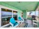 Cozy balcony with seating offering a glimpse of the ocean and beach views at 2350 N Beach Rd # 1B, Englewood, FL 34223