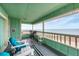 Charming covered balcony with comfortable seating and ocean views at 2350 N Beach Rd # 1B, Englewood, FL 34223