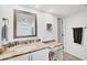 Bathroom vanity with granite countertops, a white sink, and a decorative mirror at 2350 N Beach Rd # 1B, Englewood, FL 34223