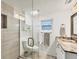 Renovated bathroom featuring a glass-enclosed shower and modern fixtures at 2350 N Beach Rd # 1B, Englewood, FL 34223