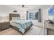 Cozy bedroom with a queen bed, soft linens, and a view of the outside buildings at 2350 N Beach Rd # 1B, Englewood, FL 34223