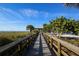 Picturesque boardwalk leading to the beach with lush greenery at 2350 N Beach Rd # 1B, Englewood, FL 34223