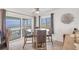 Bright dining area features a glass table and seating for four with ocean views at 2350 N Beach Rd # 1B, Englewood, FL 34223