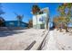 Bright exterior of a two story beach house with stairs on a sunny day at 2350 N Beach Rd # 1B, Englewood, FL 34223