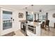 Modern kitchen with stainless steel appliances, granite countertops, and access to the ocean view balcony at 2350 N Beach Rd # 1B, Englewood, FL 34223