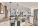 Modern kitchen featuring stainless steel appliances, granite countertops, and easy access to the living and dining areas at 2350 N Beach Rd # 1B, Englewood, FL 34223