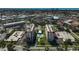 Aerial view of two condo buildings with a pool, surrounded by a city and the ocean in the background at 244 Saint Augustine Ave # 905, Venice, FL 34285