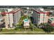 Aerial view of condo buildings, featuring a pool and landscaped grounds, and surrounding buildings at 244 Saint Augustine Ave # 905, Venice, FL 34285