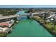 An aerial shot shows a picturesque bridge spanning over vibrant turquoise waters with buildings and lush landscapes in the backdrop at 244 Saint Augustine Ave # 905, Venice, FL 34285