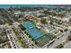 Aerial view of the community tennis and basketball courts, with parking, landscaping, and close proximity to surrounding neighborhoods at 244 Saint Augustine Ave # 905, Venice, FL 34285