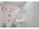 Cozy bathroom features standard fixtures, floral wallpaper, and ample storage space at 244 Saint Augustine Ave # 905, Venice, FL 34285