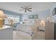 Bright bedroom boasts a ceiling fan, large windows with blinds, and nautical themed bedding at 244 Saint Augustine Ave # 905, Venice, FL 34285