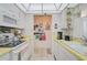 Efficient kitchen layout showcasing practical storage, counter space, and an open view to the next room at 244 Saint Augustine Ave # 905, Venice, FL 34285