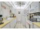 Functional kitchen featuring white cabinetry, standard appliances, and a bright, airy feel at 244 Saint Augustine Ave # 905, Venice, FL 34285
