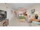 Spacious living room featuring two sofas, coffee table, lamps, and adjacent dining area and access to a balcony at 244 Saint Augustine Ave # 905, Venice, FL 34285
