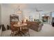 Open floor plan features a cozy living room, dining area with wood table and chairs, and view of a balcony at 244 Saint Augustine Ave # 905, Venice, FL 34285