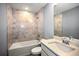 Bathroom features a tub with tile surround and a modern vanity with sink at 25259 Alcazar Dr, Punta Gorda, FL 33955