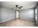 Bedroom featuring large window with blinds and ceiling fan at 25259 Alcazar Dr, Punta Gorda, FL 33955