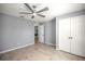 This bedroom features gray walls, a modern ceiling fan, tile flooring, and a large closet at 25259 Alcazar Dr, Punta Gorda, FL 33955