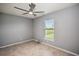 Bedroom featuring tiled floors, gray walls, ceiling fan, and a window for natural light at 25259 Alcazar Dr, Punta Gorda, FL 33955