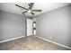 Bedroom featuring tiled floors, gray walls, ceiling fan, and a door to another room at 25259 Alcazar Dr, Punta Gorda, FL 33955