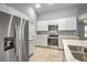 Kitchen showcases stainless steel appliances, light countertops, and white cabinets at 25259 Alcazar Dr, Punta Gorda, FL 33955