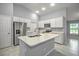 Bright kitchen features white cabinets, stainless steel appliances, and a large island with sink at 25259 Alcazar Dr, Punta Gorda, FL 33955