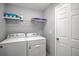 This laundry room features modern appliances, storage shelves, and a clean design at 25259 Alcazar Dr, Punta Gorda, FL 33955