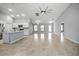 Large, open living space with tile flooring and a ceiling fan, perfect for entertaining at 25259 Alcazar Dr, Punta Gorda, FL 33955