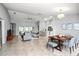 Open-concept living area with tile flooring, modern furnishings, a ceiling fan, and ample natural light at 25259 Alcazar Dr, Punta Gorda, FL 33955
