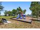 Community playground with slides and playground equipment on a sunny day at 25259 Alcazar Dr, Punta Gorda, FL 33955