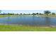 Scenic pond with a fountain as a water feature on a bright sunny day at 25259 Alcazar Dr, Punta Gorda, FL 33955